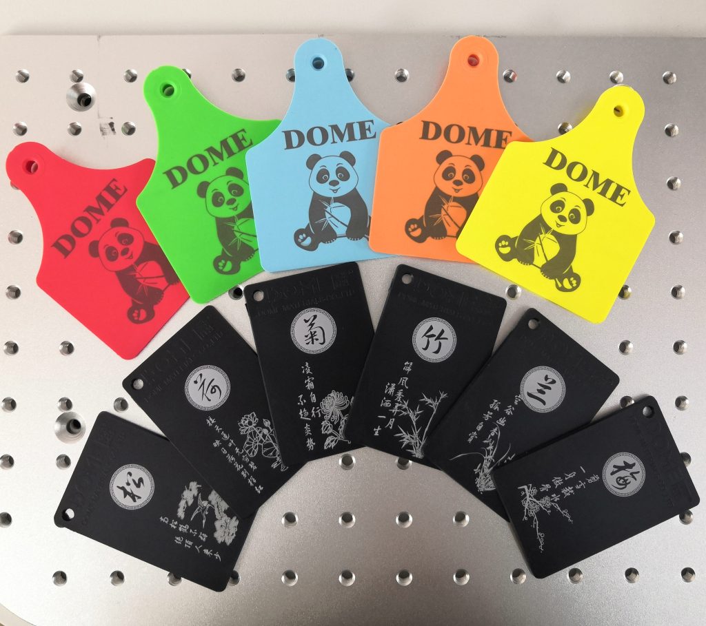 Black laser marking on colored TPU ear tags and white laser marking on black plastic molded parts